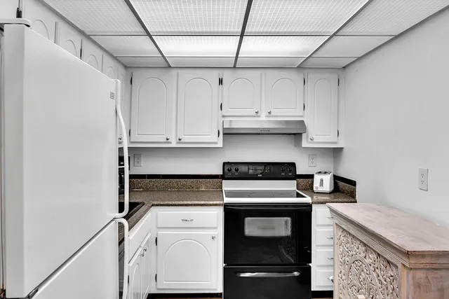 a bedroom with a bed dresser and a window