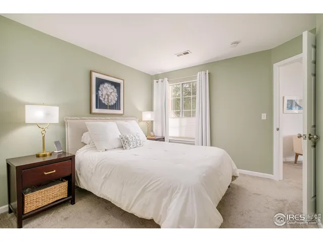 a bedroom with a bed and a night stand