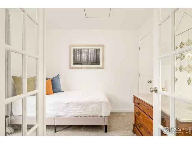 a bedroom with a bed couch and a window