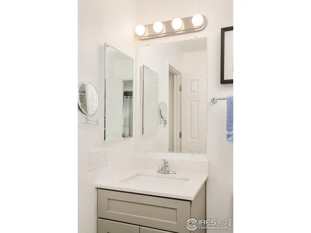 a bathroom with a sink a mirror and a shower