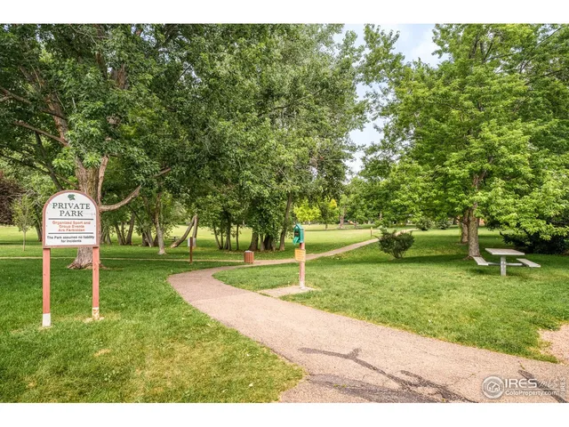 a garden with trees in the background