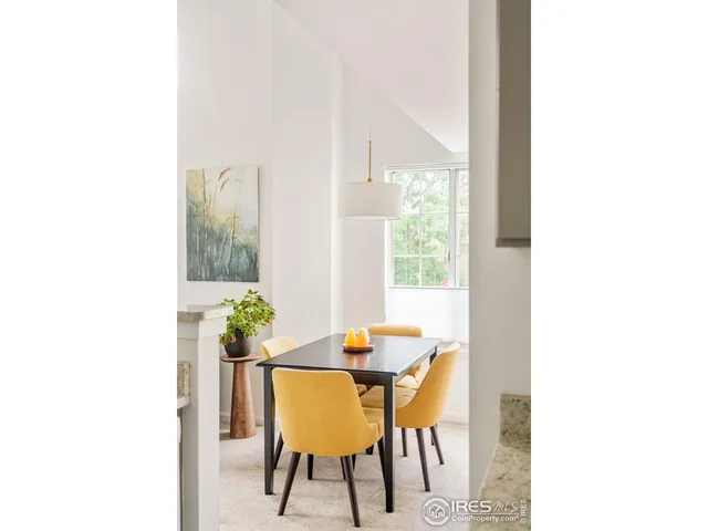 a view of a dining room with furniture and a potted plant
