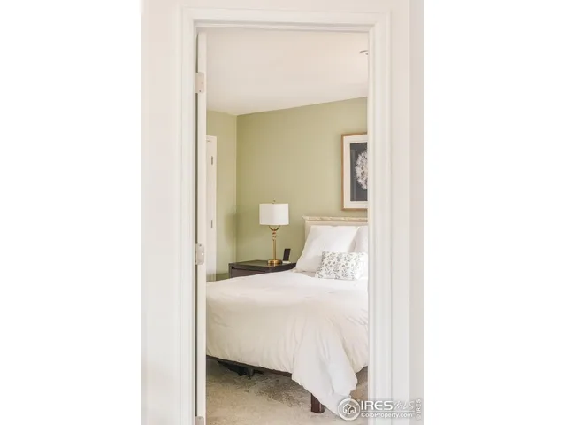 a bedroom with a bed and a mirror