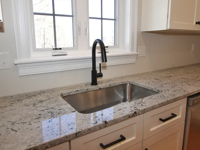 a view white cabinets and a large window