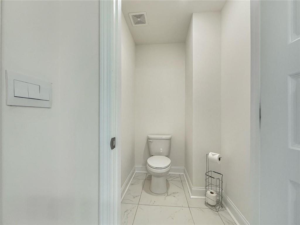 1160 Kendron Lane, Unit 16 Atlanta, GA 30329 - Photo 24 of 39 a white toilet sitting next to a white cabinet
