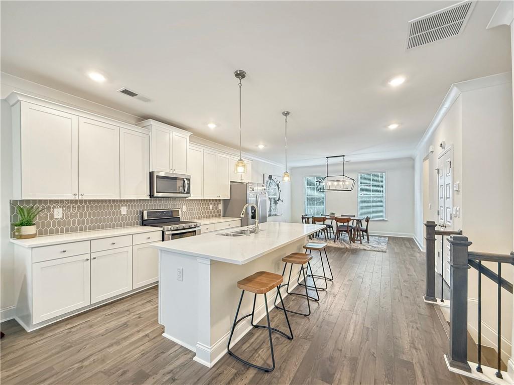 1160 Kendron Lane, Unit 16 Atlanta, GA 30329 - Photo 3 of 39 a kitchen with a stove a sink and a refrigerator