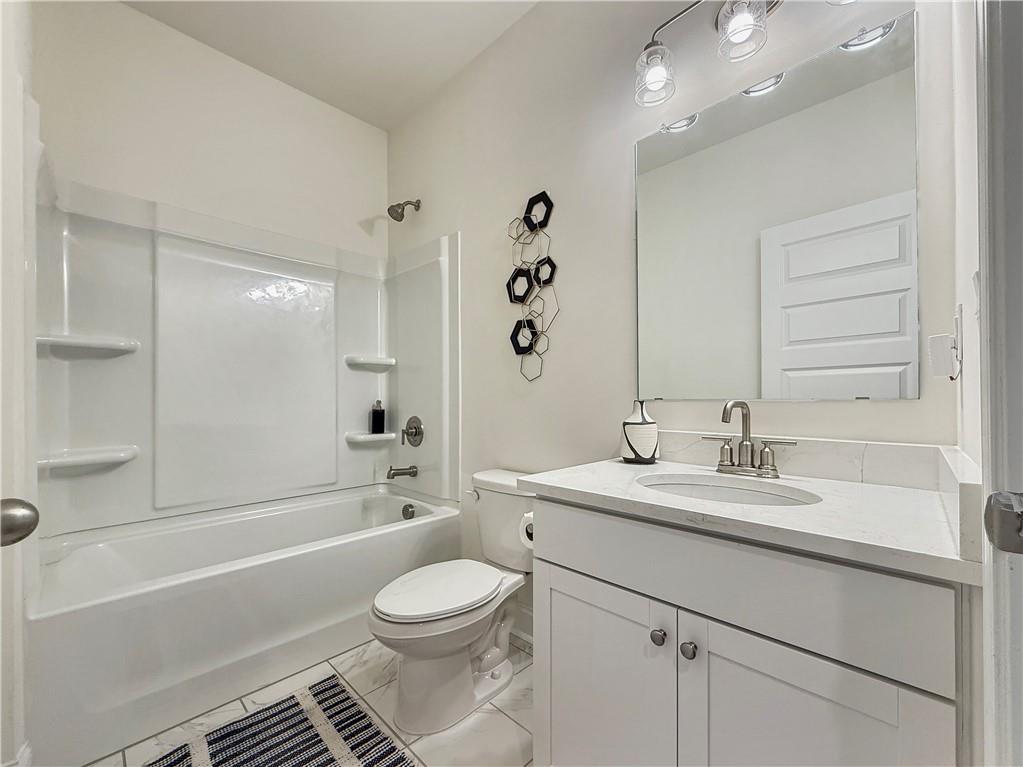 1160 Kendron Lane, Unit 16 Atlanta, GA 30329 - Photo 38 of 39 a bathroom with a bathtub shower sink vanity mirror and toilet