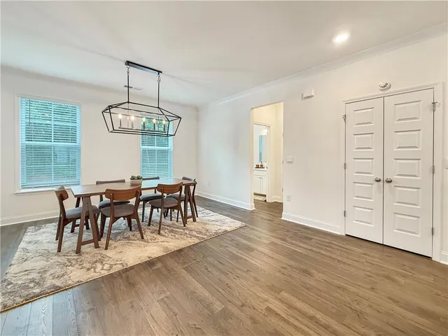 a view of a dining room with furniture window and wooden floor