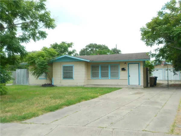 a front view of a house with a garden and yard