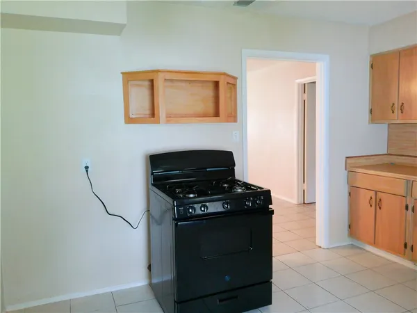 a kitchen with a stove and a refrigerator