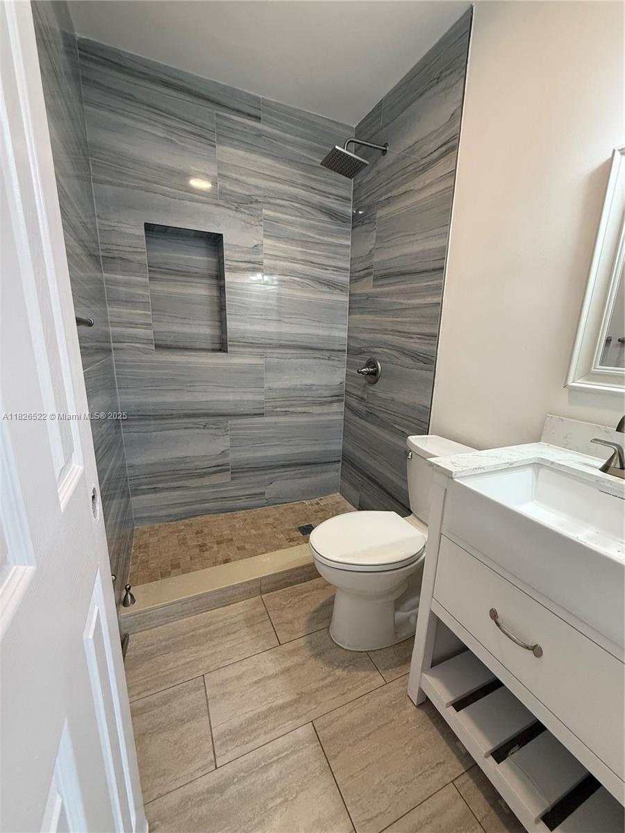 Flagami Miami, FL 33144 - Photo 11 of 20 a bathroom with a toilet a sink and shower