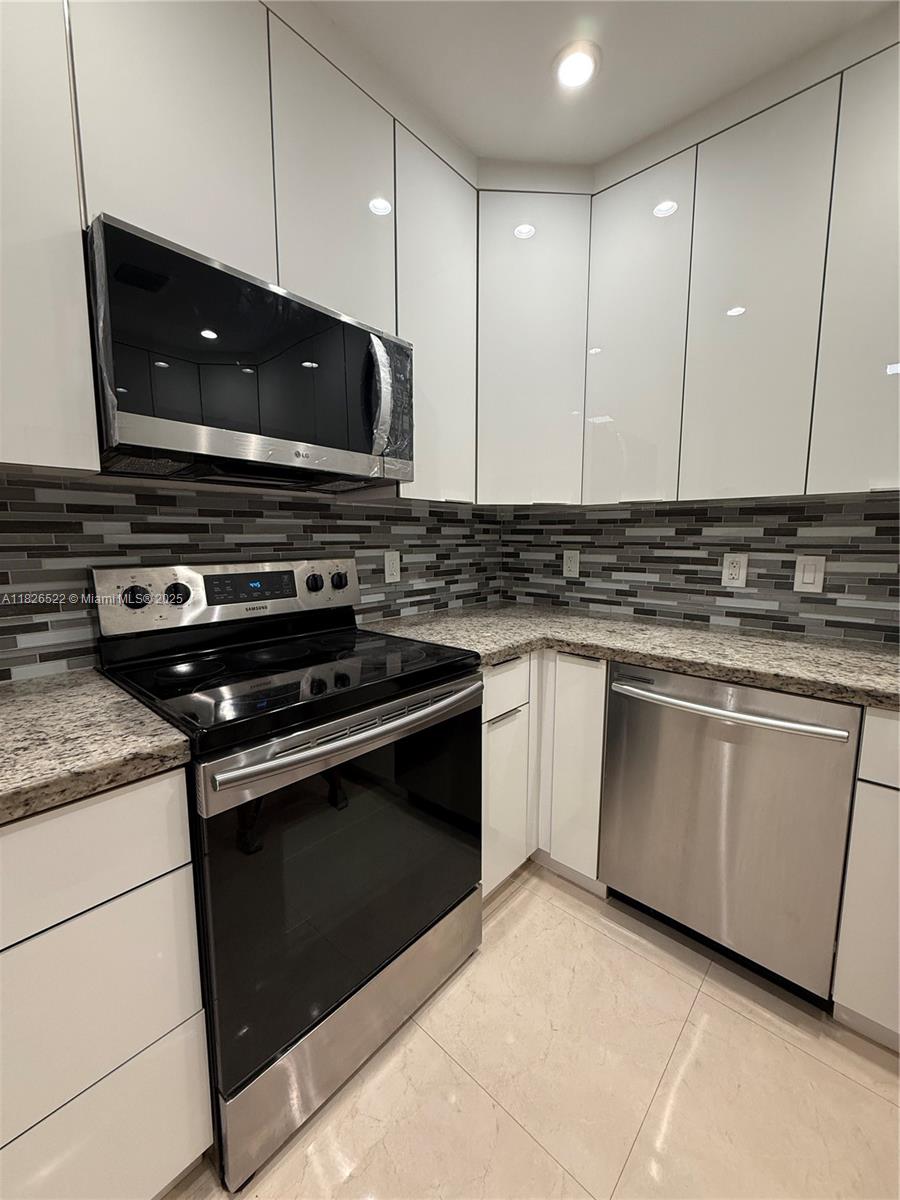 Flagami Miami, FL 33144 - Photo 14 of 20 a kitchen with a stove and a microwave