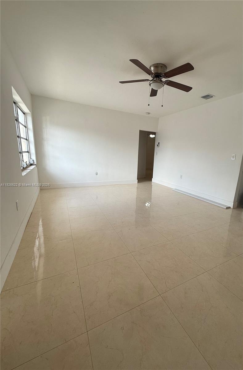 Flagami Miami, FL 33144 - Photo 4 of 20 an empty room with a ceiling fan and a window