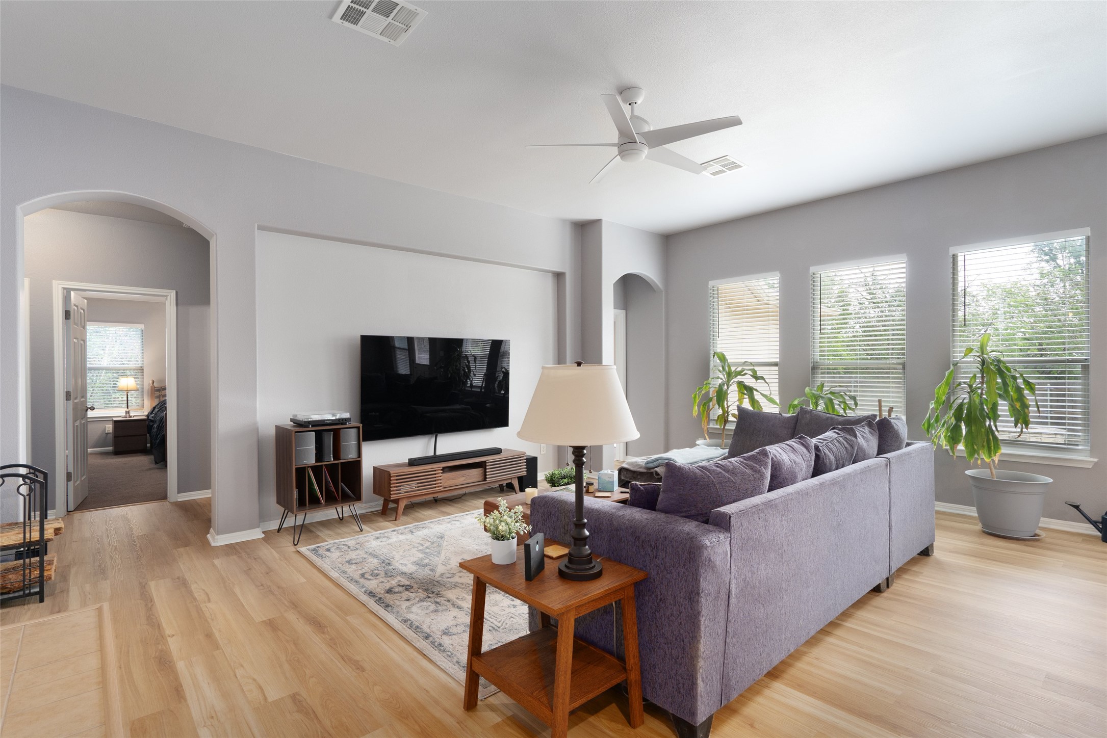 7013 Cromarty Lane Austin, TX 78754 - Photo 12 of 37 Living area with light-colored flooring, light grey walls, and a ceiling fan