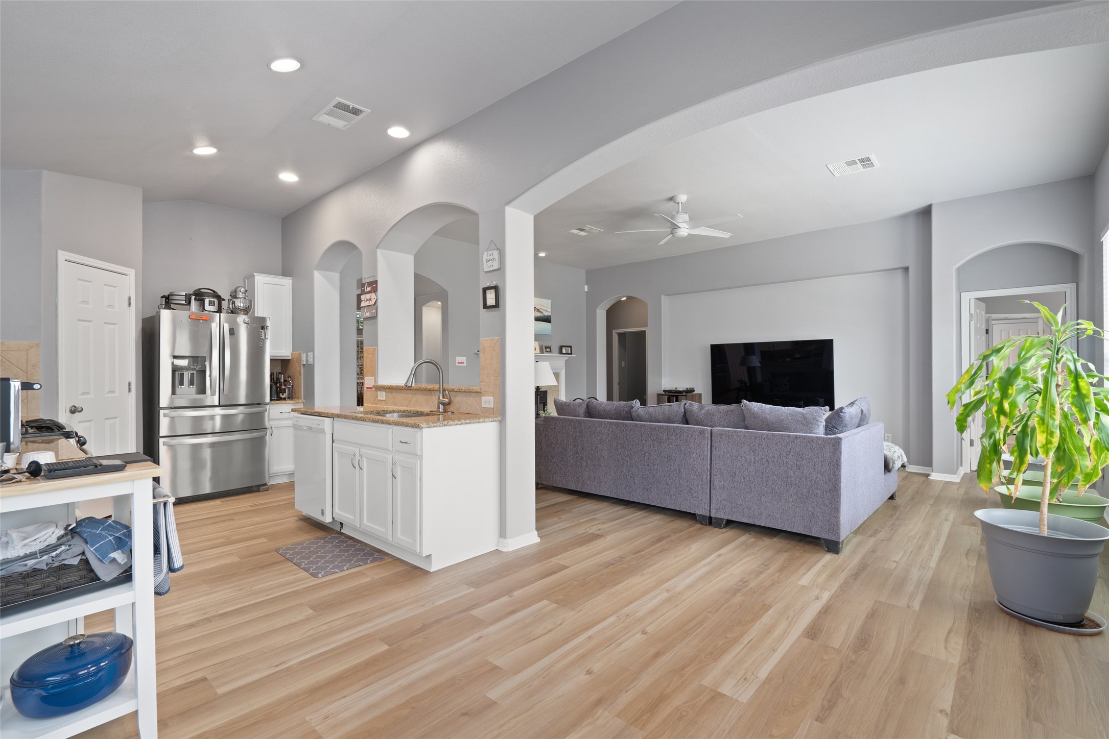7013 Cromarty Lane Austin, TX 78754 - Photo 15 of 37 The open concept living area features light wood-look flooring and recessed lighting