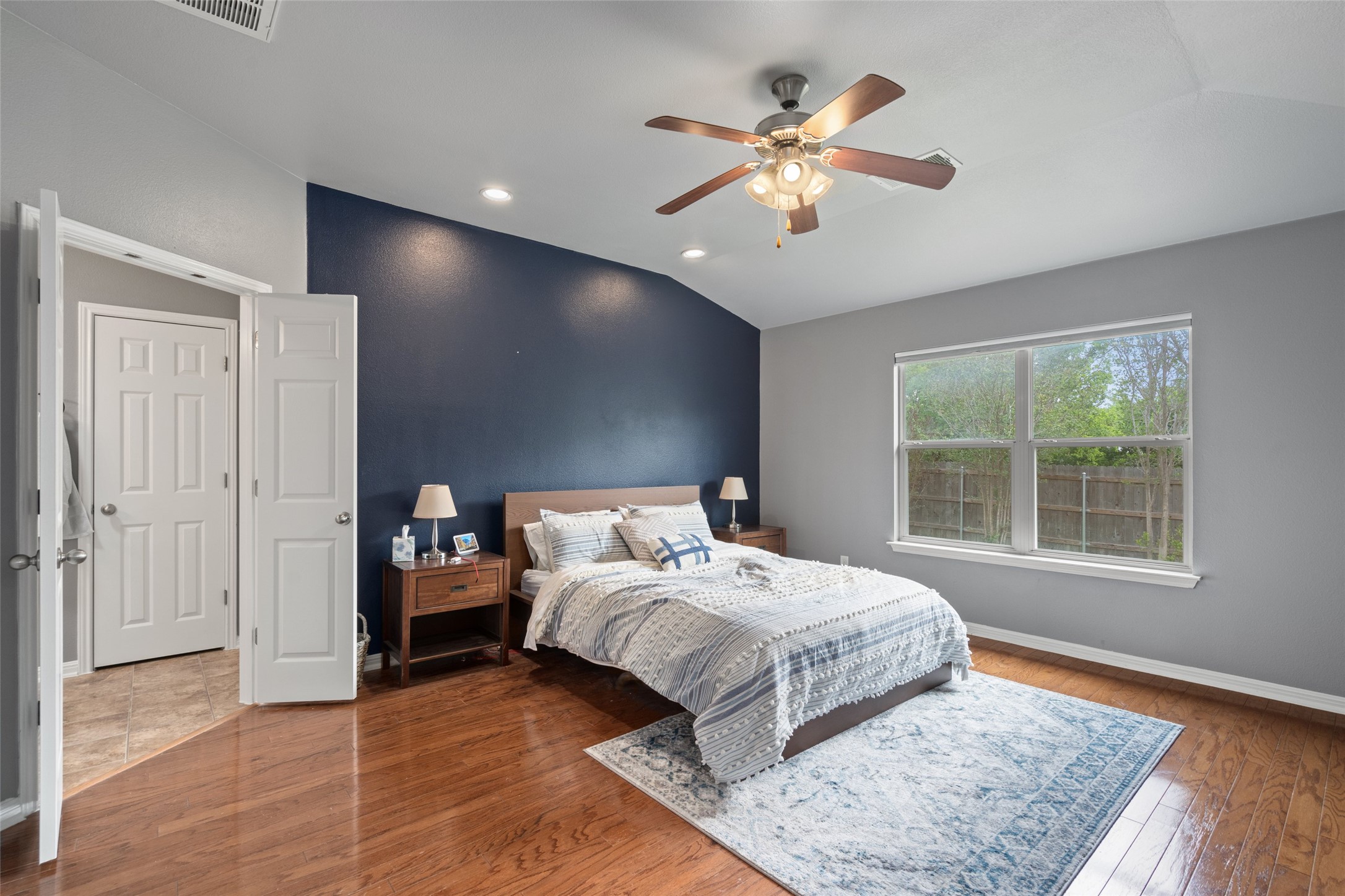 7013 Cromarty Lane Austin, TX 78754 - Photo 20 of 37 This room features hardwood flooring, a ceiling fan, and a window providing natural light