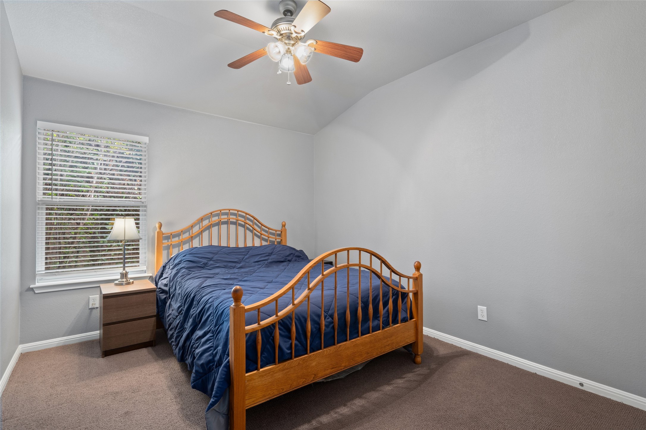 7013 Cromarty Lane Austin, TX 78754 - Photo 25 of 37 Bedroom featuring a ceiling fan with light fixture, a window with blinds, and carpeted flooring