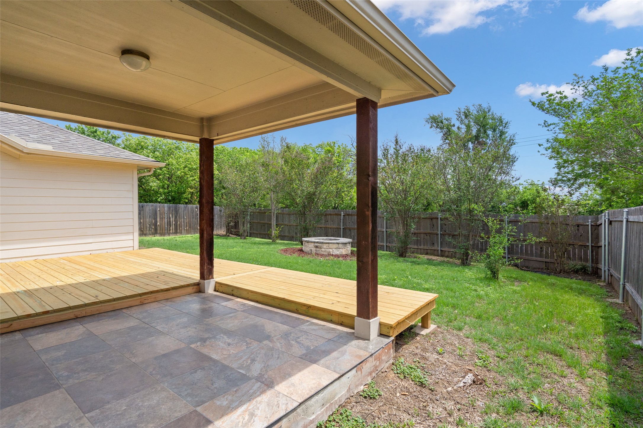 7013 Cromarty Lane Austin, TX 78754 - Photo 32 of 37 The property features a covered patio with tiled flooring, extending to a wooden deck