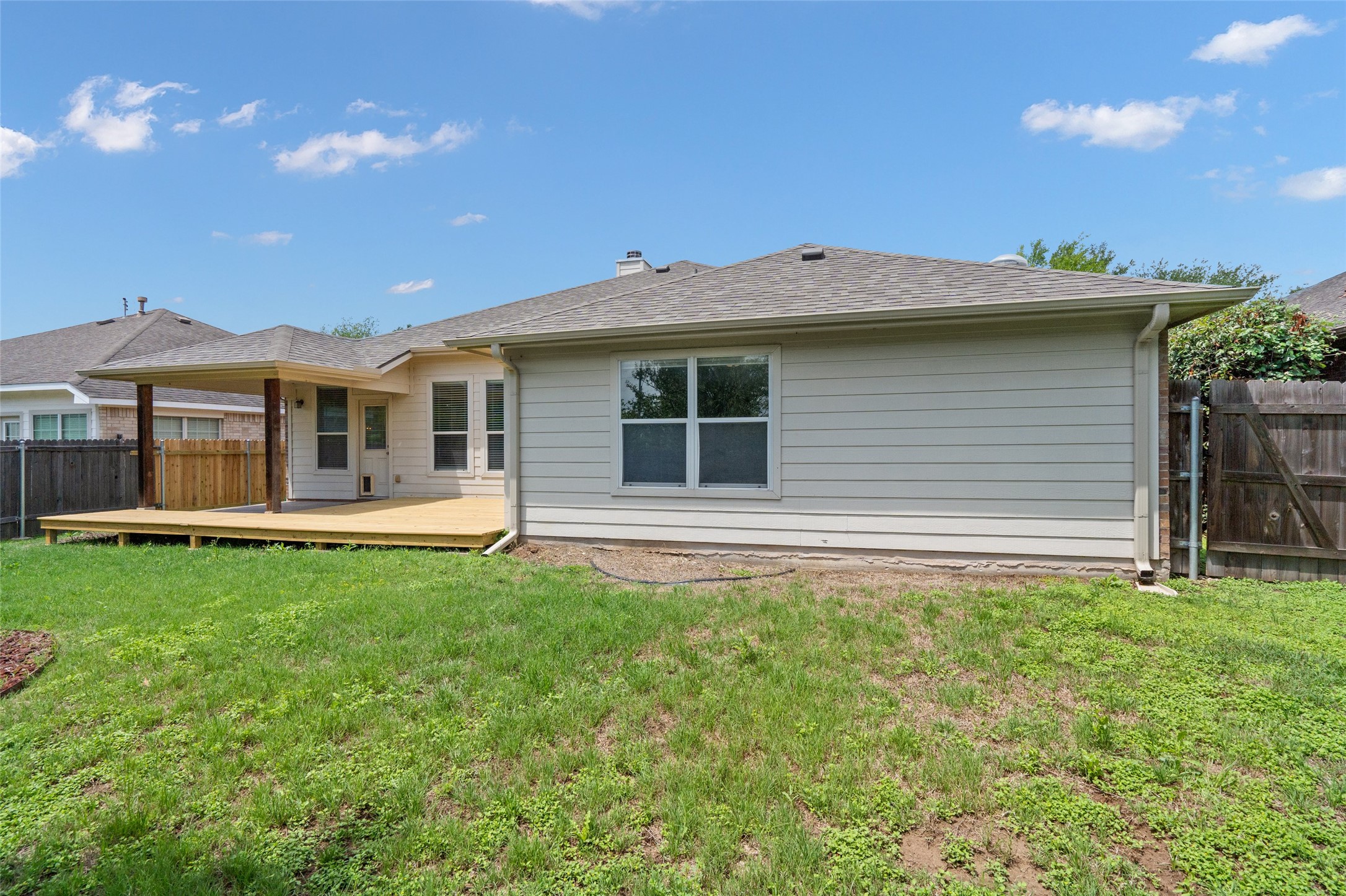 7013 Cromarty Lane Austin, TX 78754 - Photo 36 of 37 The property features a fenced yard with a spacious wooden deck and a covered patio area