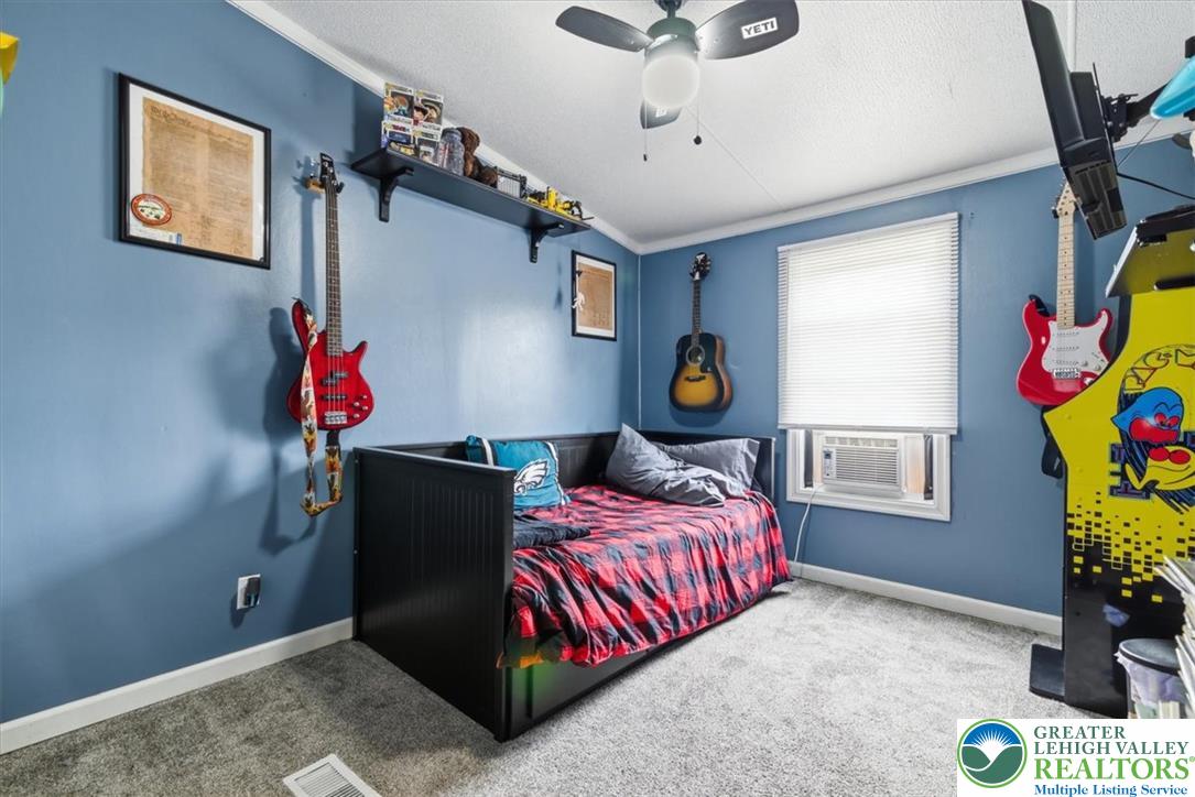 634 Main Road Lehighton, PA 18235 - Photo 27 of 39 A well-appointed bedroom featuring a comfortable bed and vibrant blue walls.