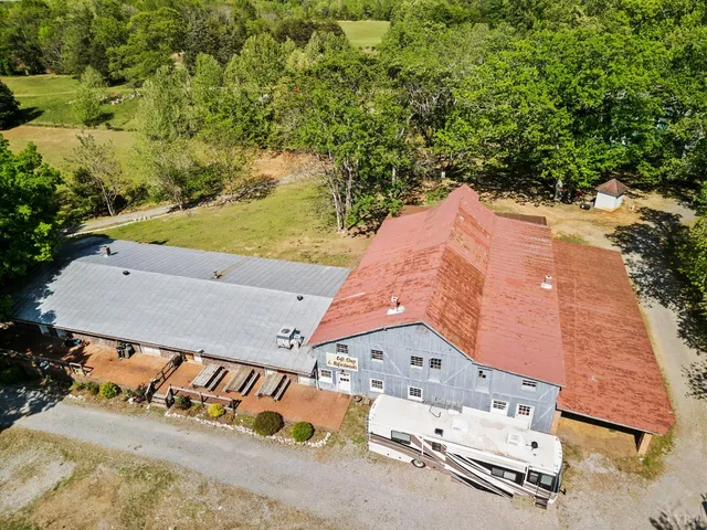 an aerial view of a house with a yard and lake view