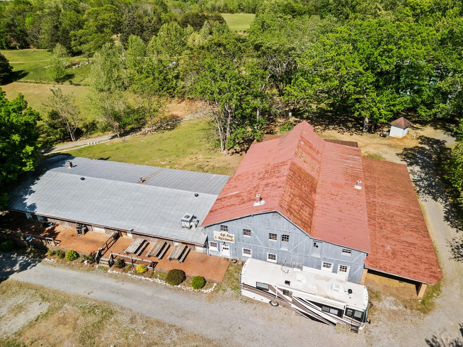 an aerial view of a house with a yard and lake view