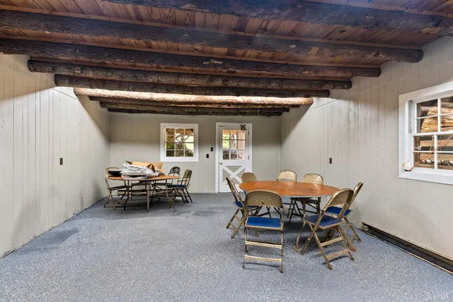 a backyard of a house with table and chairs