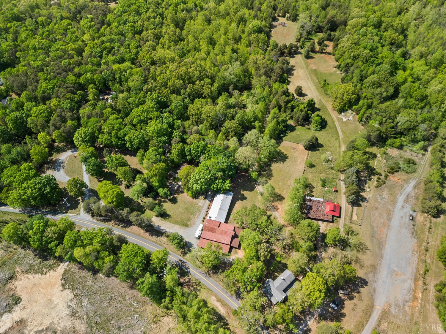 4067 Dickerson Mill Road Bedford, VA 24523 - Photo 82 of 90 an aerial view of residential house with outdoor space and trees all around