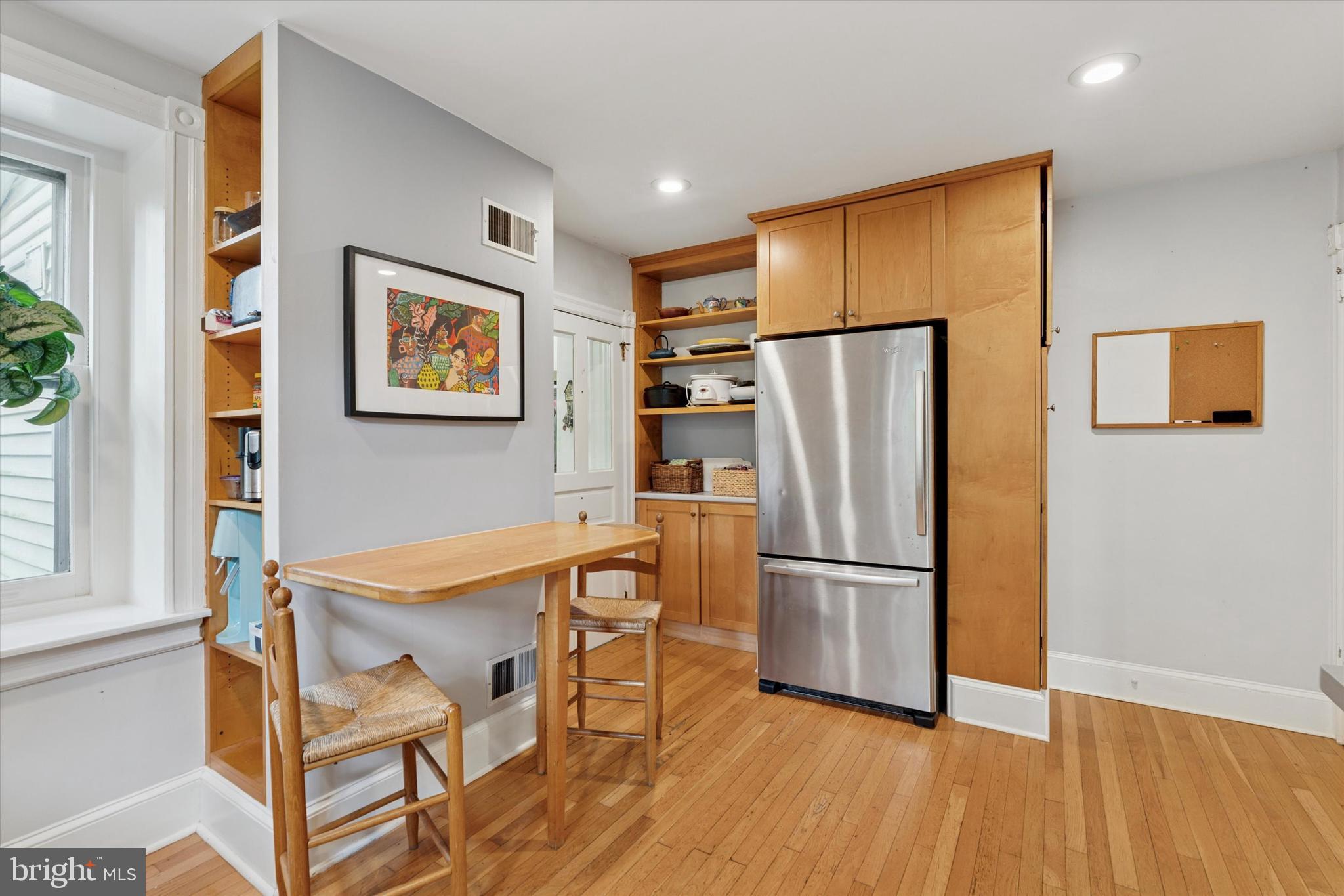 156 Idris Road Merion Station, PA 19066 - Photo 13 of 33 a kitchen with stainless steel appliances refrigerator and wooden floor