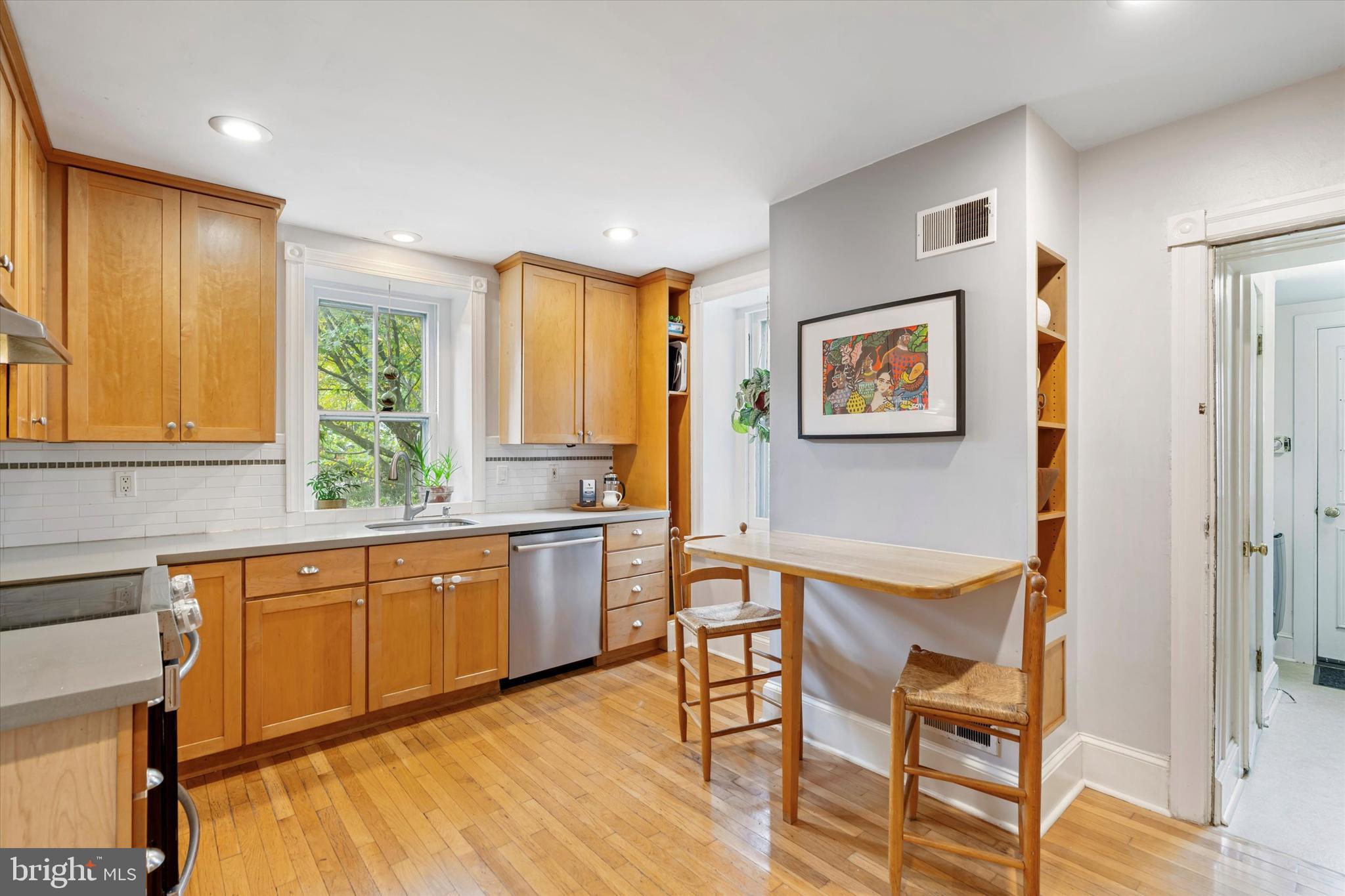 156 Idris Road Merion Station, PA 19066 - Photo 14 of 33 a kitchen with stainless steel appliances granite countertop a refrigerator and wooden cabinets