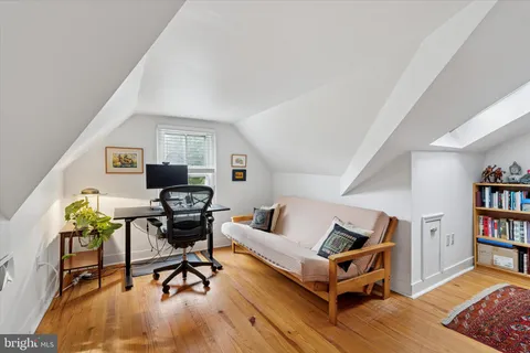 a living room with furniture and a book shelf
