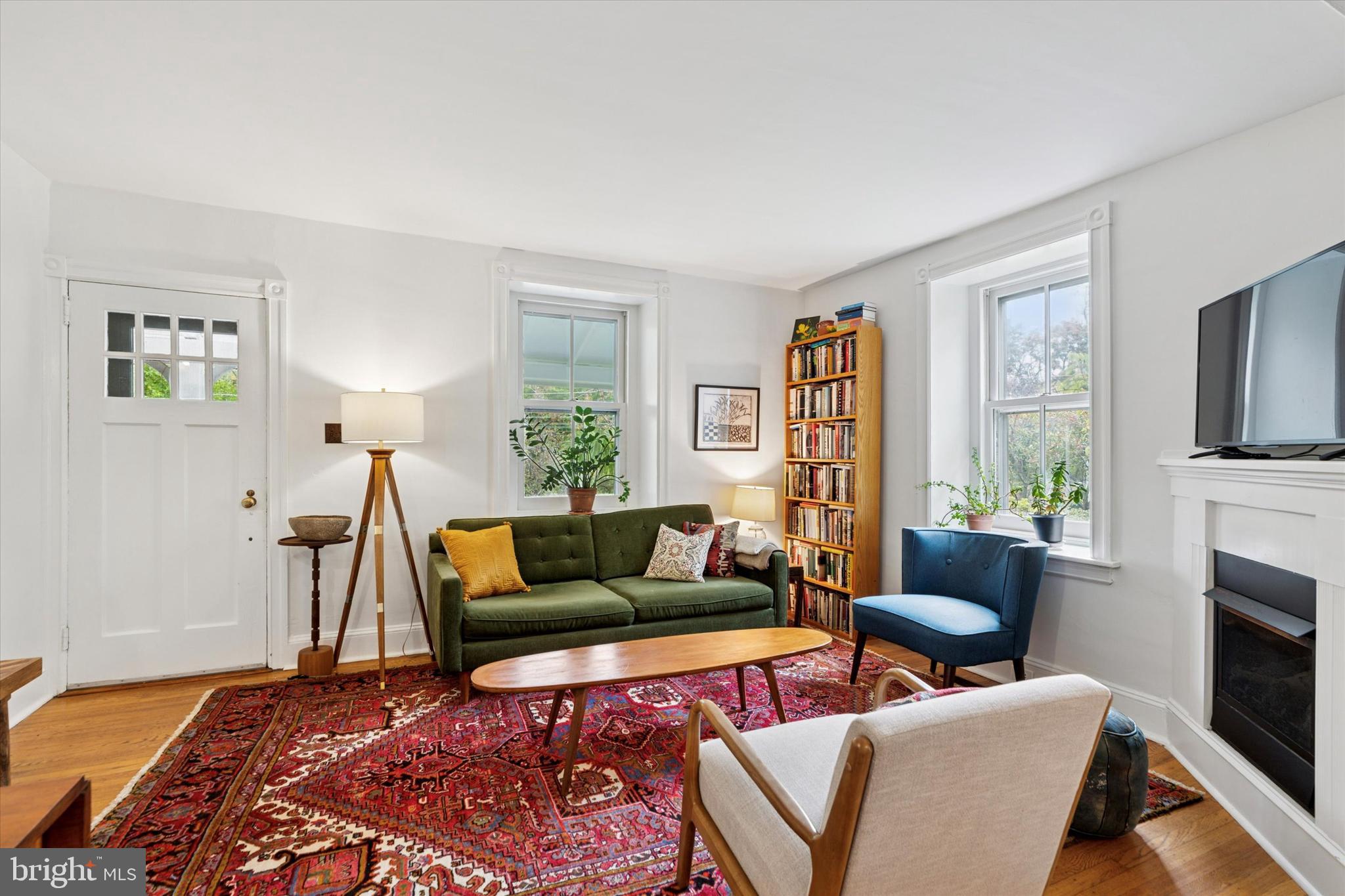 156 Idris Road Merion Station, PA 19066 - Photo 5 of 33 a living room with furniture a flat screen tv and a fireplace