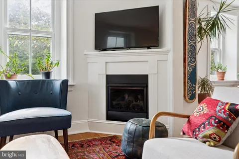 a living room with furniture fireplace and flat screen tv
