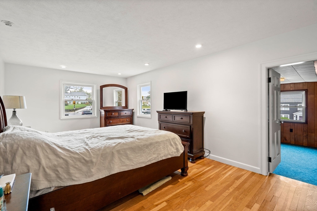 390 Central Avenue Milton, MA 02186 - Photo 20 of 33 a bedroom with a bed and a flat screen tv