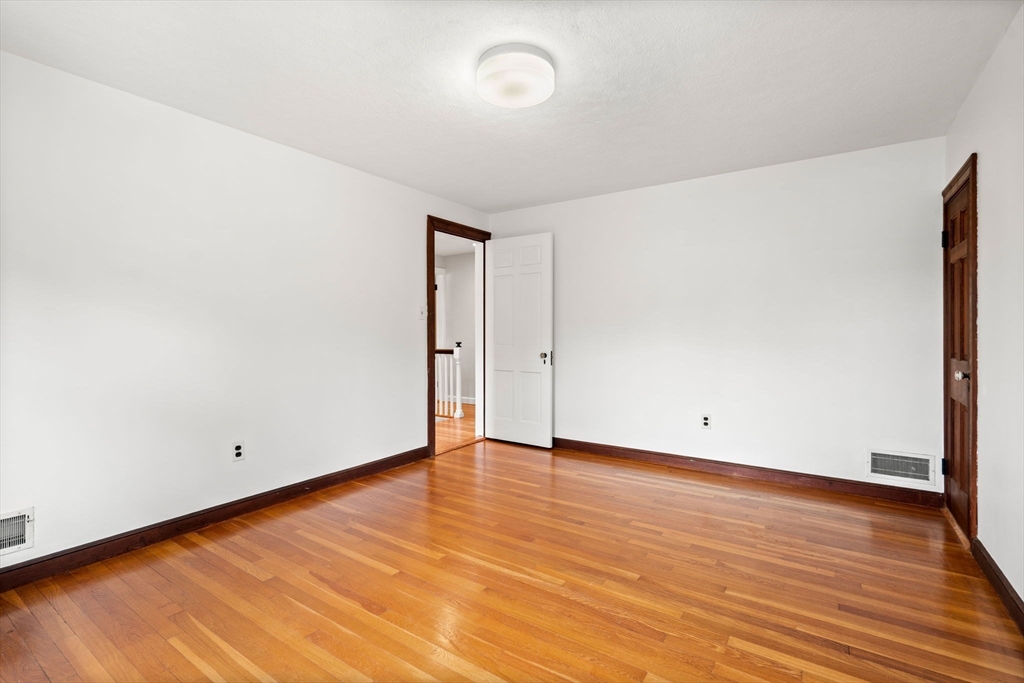 390 Central Avenue Milton, MA 02186 - Photo 22 of 33 a view of an empty room with wooden floor