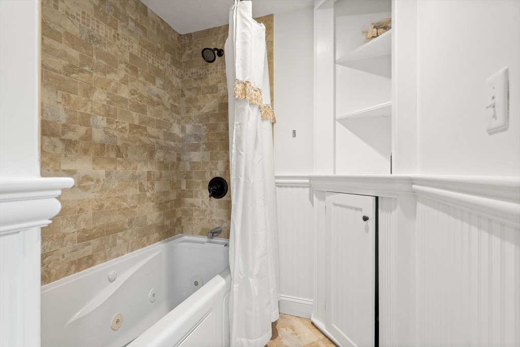 390 Central Avenue Milton, MA 02186 - Photo 25 of 33 a bathroom with a bathtub