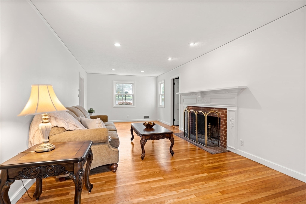 390 Central Avenue Milton, MA 02186 - Photo 6 of 33 a living room with furniture a fireplace and a flat screen tv