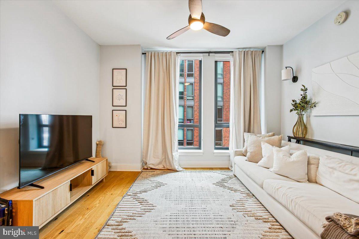 1211 Van Street Southeast, Unit 902 Washington, DC 20003 - Photo 13 of 43 a living room with furniture and a flat screen tv