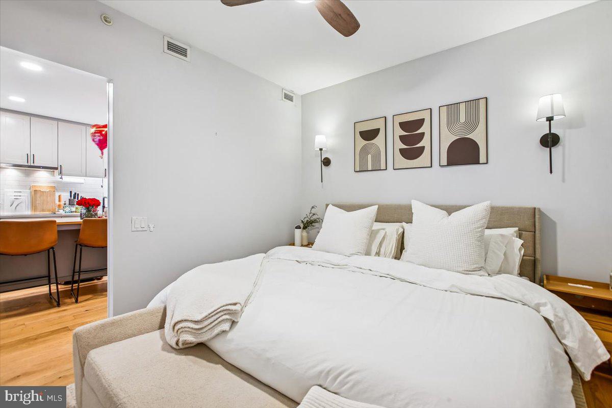 1211 Van Street Southeast, Unit 902 Washington, DC 20003 - Photo 18 of 43 a bedroom with a bed and a chair