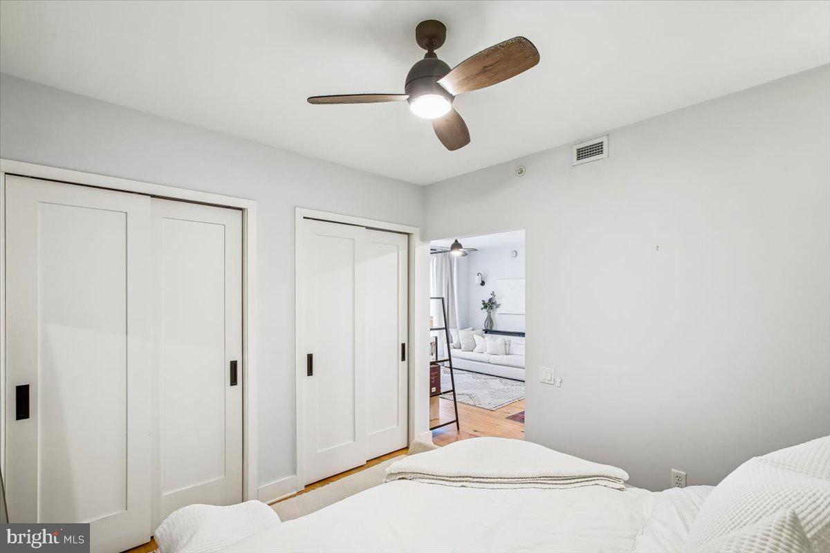 1211 Van Street Southeast, Unit 902 Washington, DC 20003 - Photo 19 of 43 a bedroom with a bed and a chandelier fan