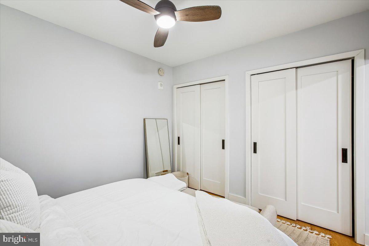 1211 Van Street Southeast, Unit 902 Washington, DC 20003 - Photo 20 of 43 a bedroom with a bed and a chandelier fan