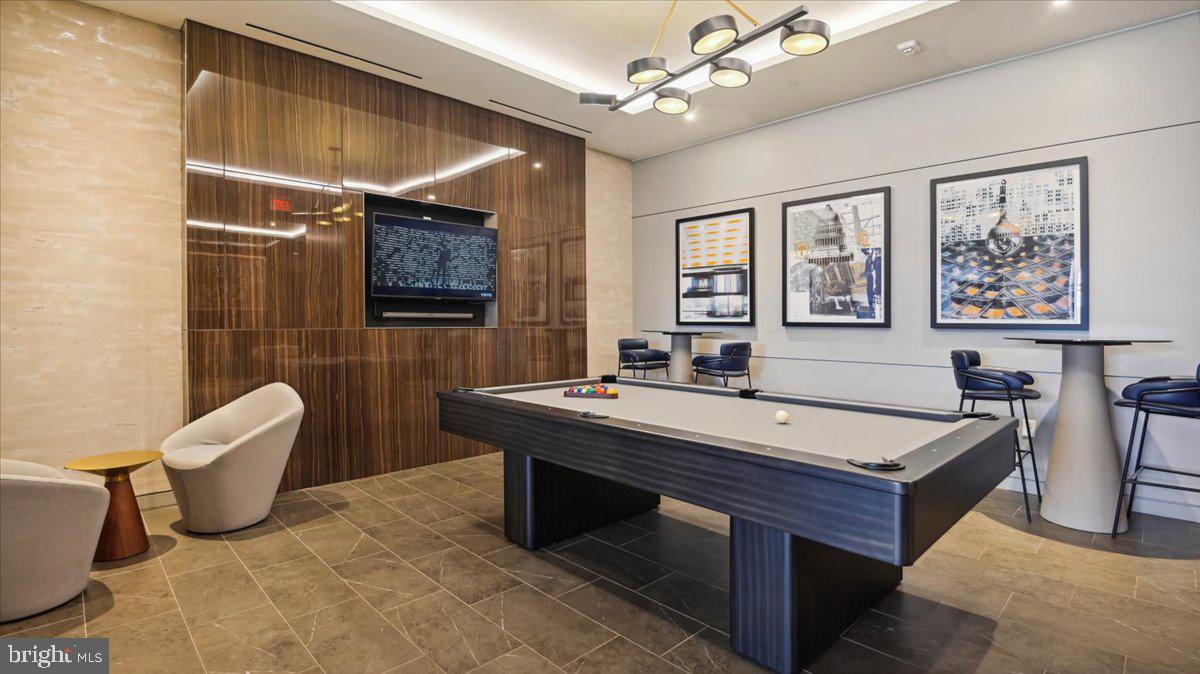 1211 Van Street Southeast, Unit 902 Washington, DC 20003 - Photo 25 of 43 a room with pool table and windows