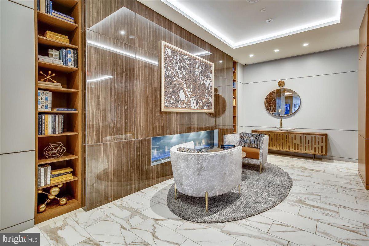 1211 Van Street Southeast, Unit 902 Washington, DC 20003 - Photo 26 of 43 a living room with couch and a book shelf