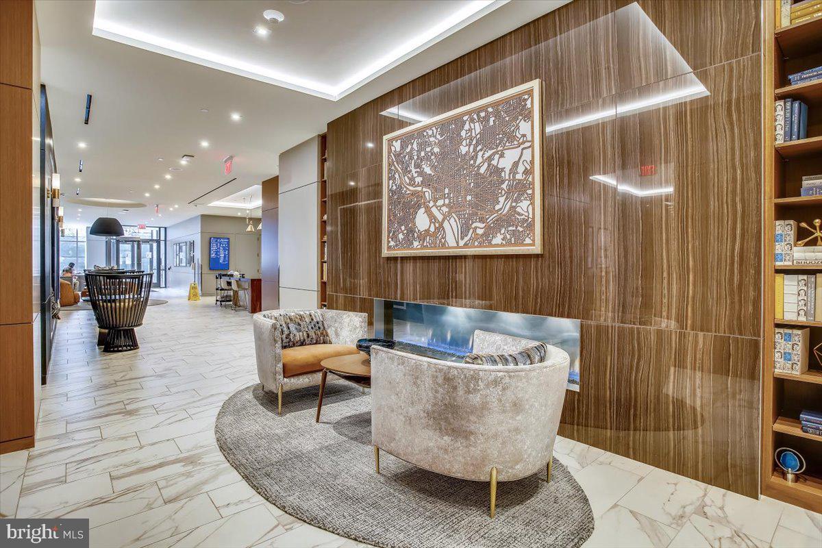 1211 Van Street Southeast, Unit 902 Washington, DC 20003 - Photo 27 of 43 a living room with furniture and kitchen view