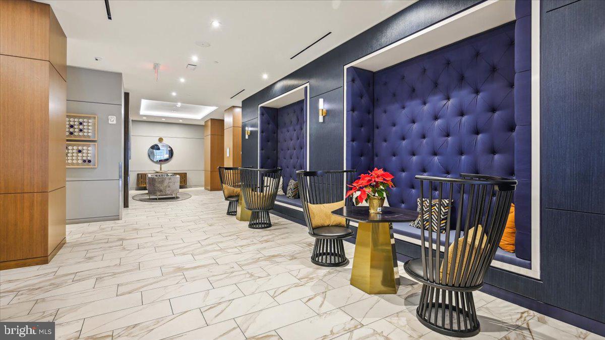 1211 Van Street Southeast, Unit 902 Washington, DC 20003 - Photo 28 of 43 a room with lots of white furniture and window