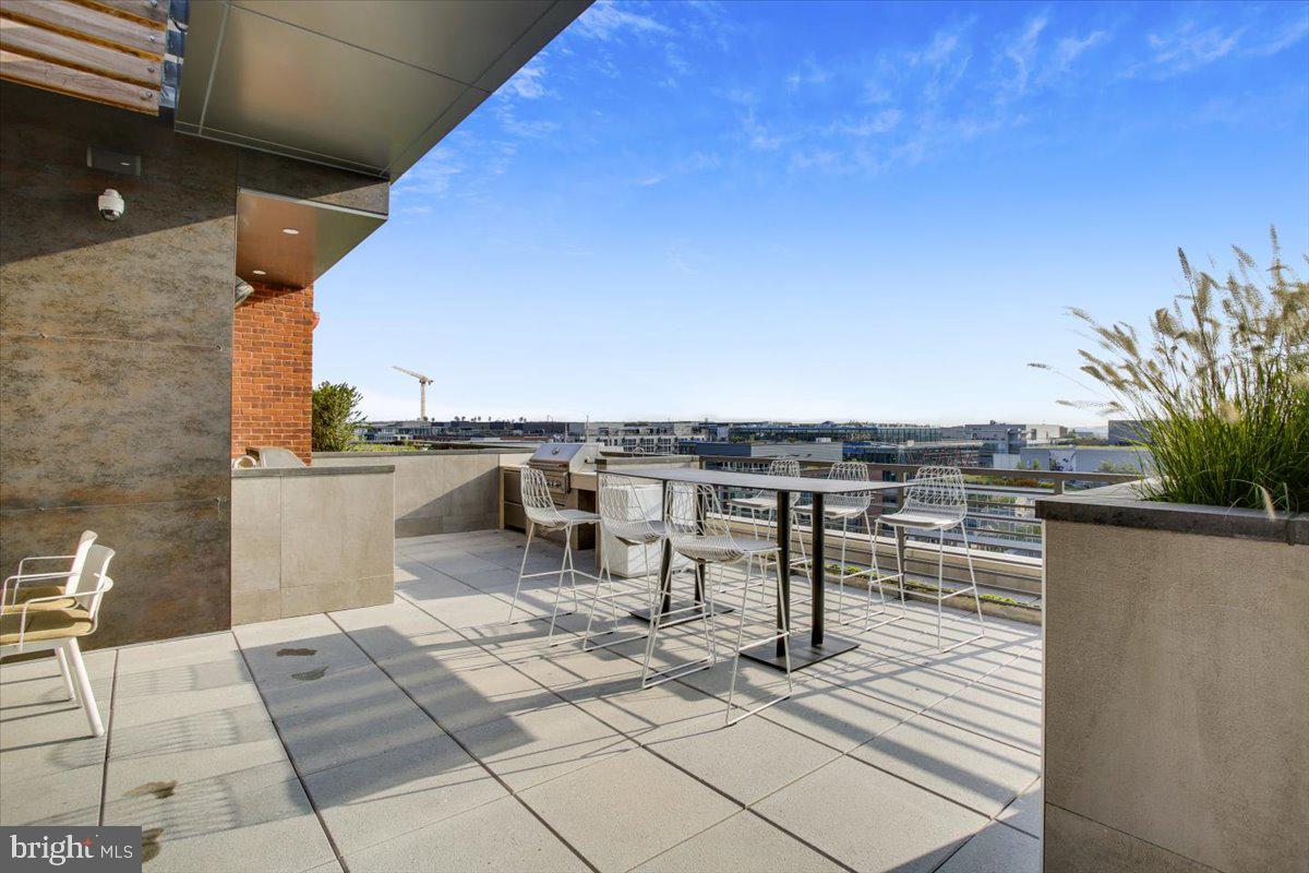 1211 Van Street Southeast, Unit 902 Washington, DC 20003 - Photo 32 of 43 a terrace with a table and chairs