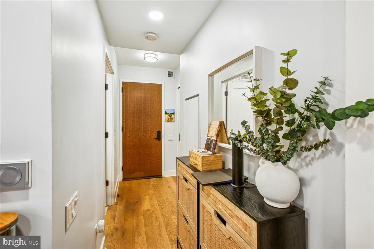 1211 Van Street Southeast, Unit 902 Washington, DC 20003 - Photo 4 of 43 a bathroom with a granite countertop sink and a mirror