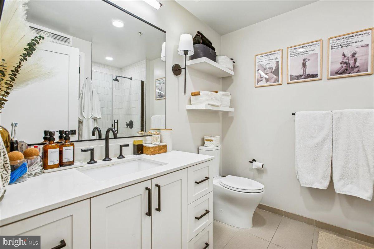 1211 Van Street Southeast, Unit 902 Washington, DC 20003 - Photo 6 of 43 a bathroom with a double vanity sink mirror and toilet