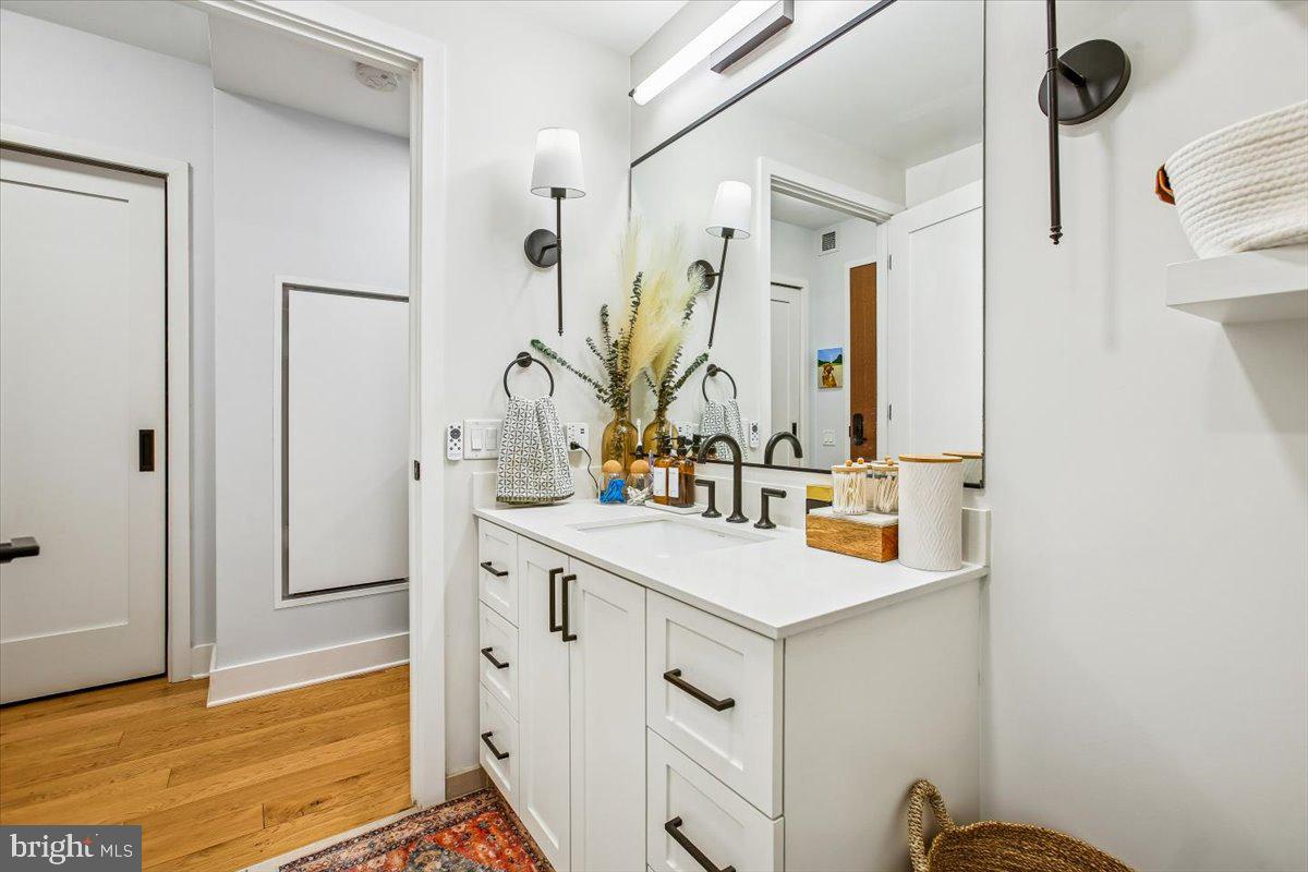 1211 Van Street Southeast, Unit 902 Washington, DC 20003 - Photo 7 of 43 a bathroom with a sink and a mirror