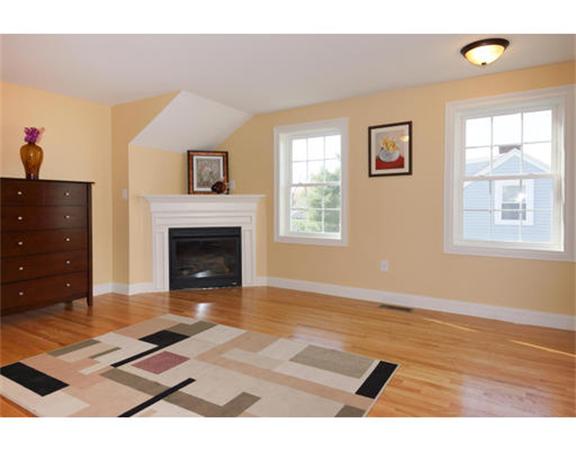 23 Mott Street, Unit 1 Arlington, MA 02474 - Photo 20 of 28 a living room with furniture and a fireplace
